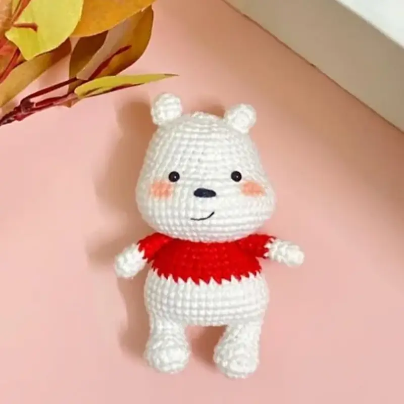 How to Crochet a Polar Bear Amigurumi for Winter, the finished crochet build, photographed on a plain surface